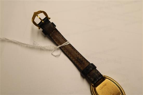 A ladys 18ct gold Cartier oval cased wrist watch, with Cartier box.